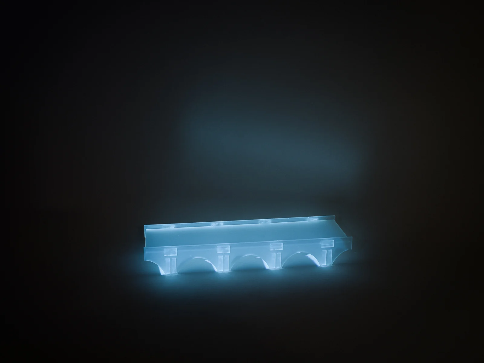 Projected light follows the acrylic bridge’s deck and supports