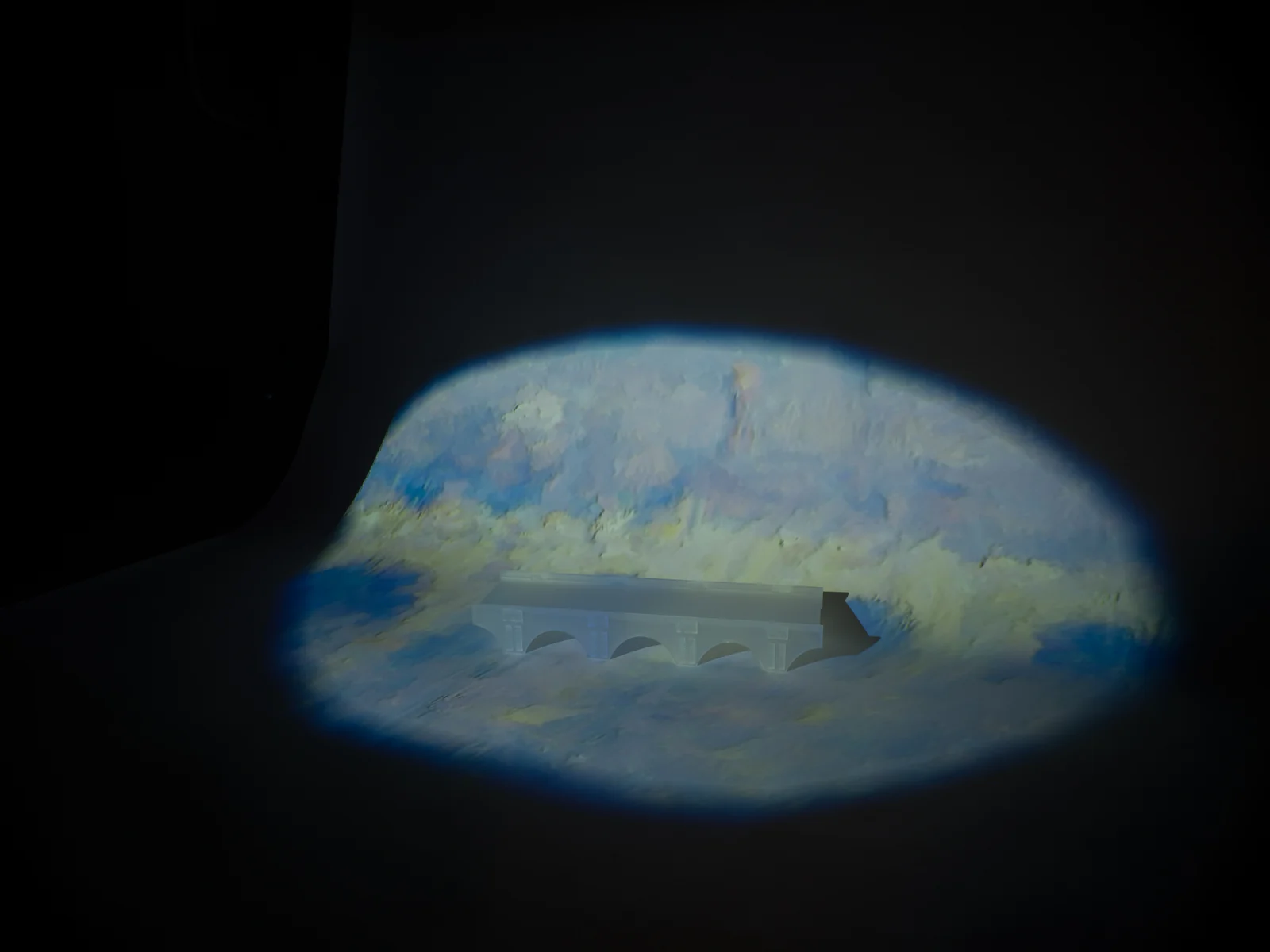 A Monet-inspired projection extends across and around the bridge model