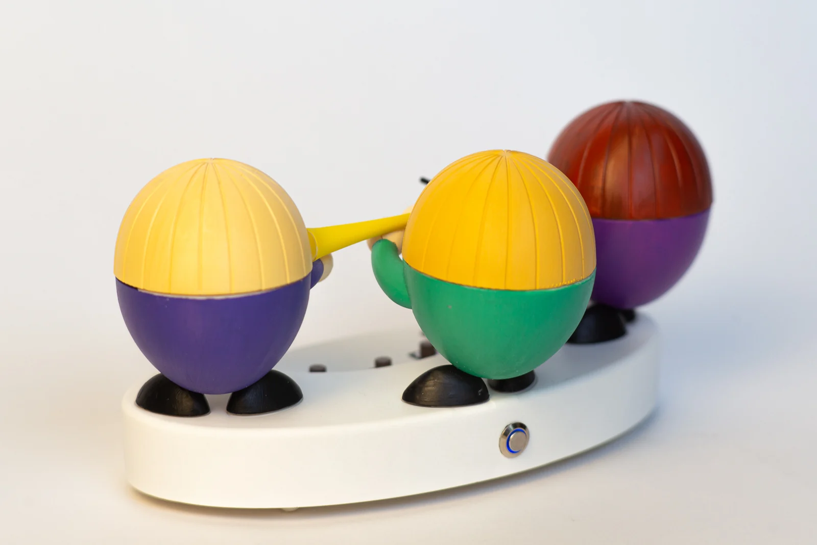 The backs of the three musicians on the white base