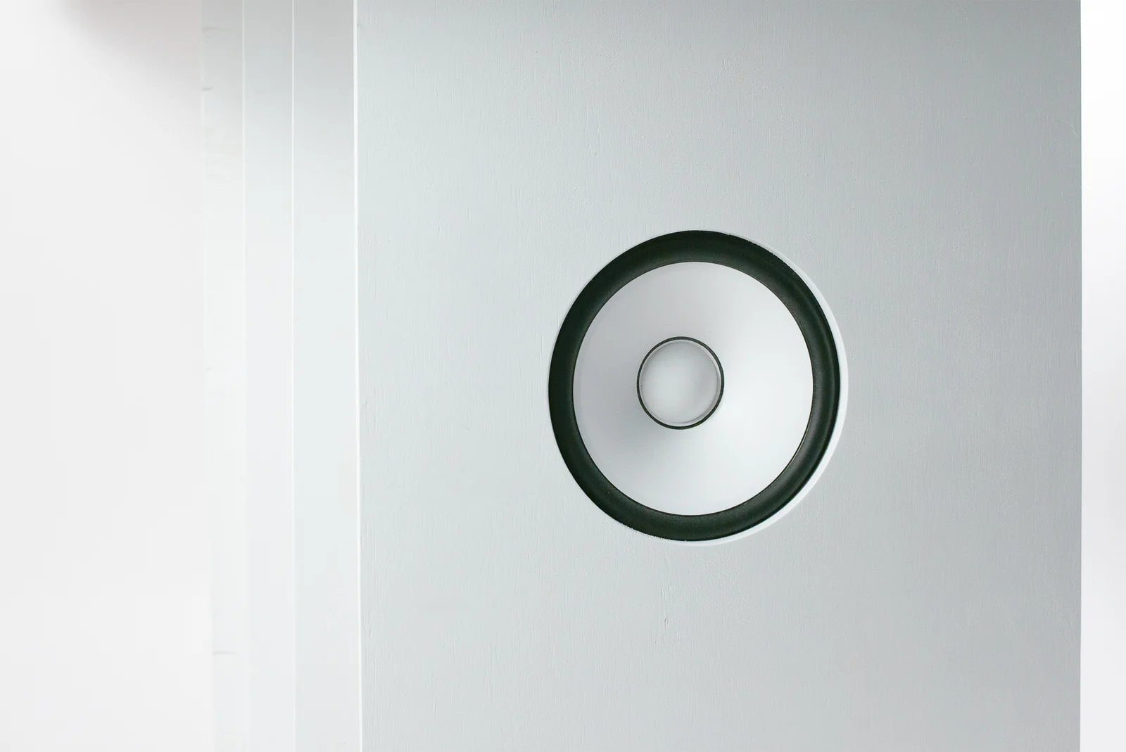 A round speaker set into the side of the Space Audition cabinet
