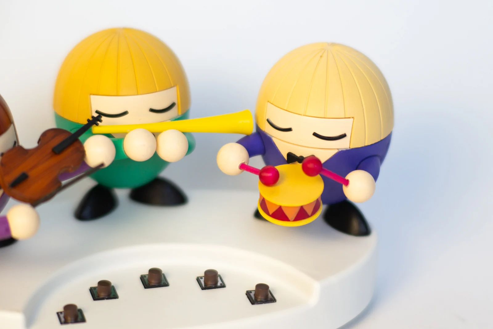 The flute player and drummer beside the five control buttons