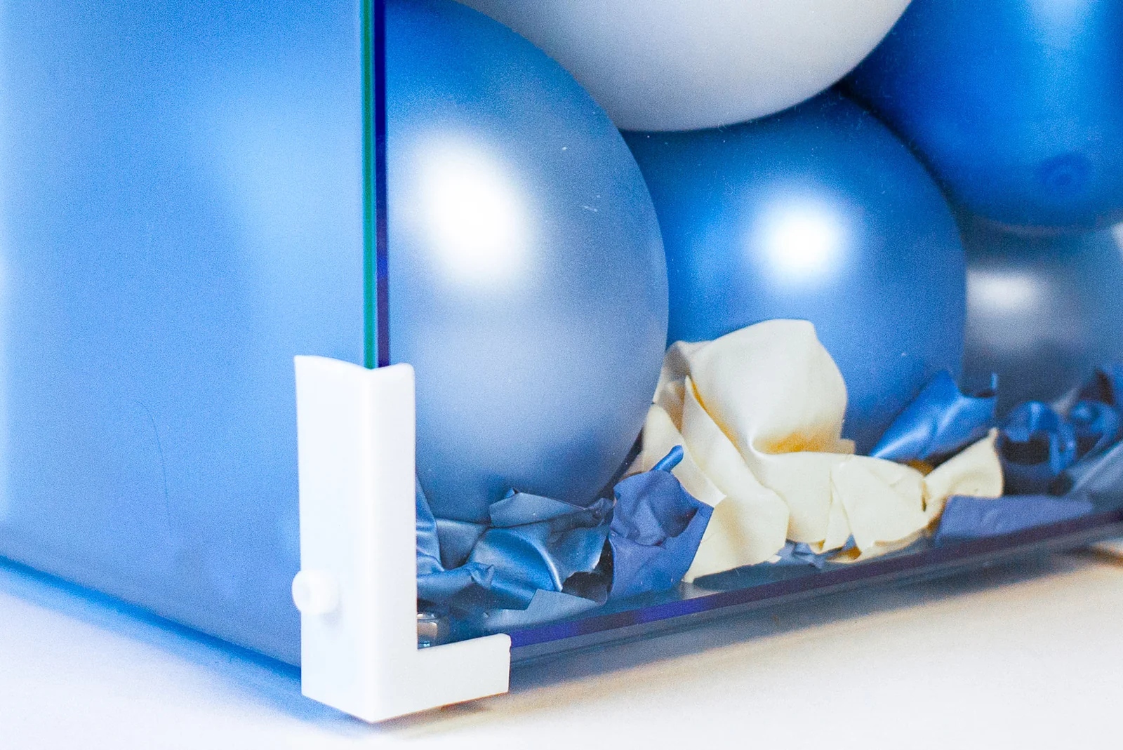 Inflated balloons above fragments collected at the bottom of the enclosure