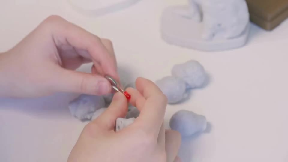 Hands fitting the illuminated face of the statue