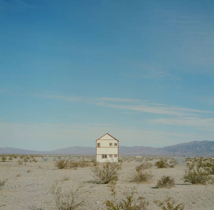 A small pale building in the desert