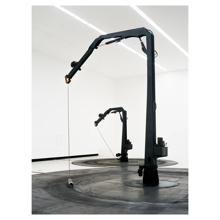 Dark sculptural forms in a bright gallery