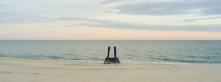 Two posts standing in a calm sea